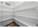 Spacious walk-in pantry with ample wire shelving and wood-look flooring at 3720 Edsel Ave, St Cloud, FL 34772