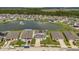 Stunning aerial view of a residential community with a central pond and well-maintained lawns at 374 Pine Tree Bridge Trl, St Cloud, FL 34772
