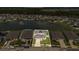 Aerial view of a house in a community with a large pond, highlighting property's location at 374 Pine Tree Bridge Trl, St Cloud, FL 34772
