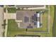 Aerial shot showcasing the house's rooftop solar panels and backyard play area at 374 Pine Tree Bridge Trl, St Cloud, FL 34772