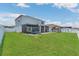 Large backyard featuring a covered patio, playset, trampoline, and views of the lake at 374 Pine Tree Bridge Trl, St Cloud, FL 34772
