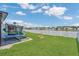Spacious backyard featuring a trampoline and a playset overlooking the lake at 374 Pine Tree Bridge Trl, St Cloud, FL 34772