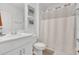 Bathroom with white cabinets, framed artwork, and shower with curtain at 374 Pine Tree Bridge Trl, St Cloud, FL 34772