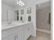 Bright bathroom with double sinks, a large mirror, and a colorful shower curtain at 374 Pine Tree Bridge Trl, St Cloud, FL 34772