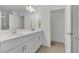 Bright bathroom featuring double sinks, white cabinetry, and a large mirror with modern lighting at 374 Pine Tree Bridge Trl, St Cloud, FL 34772