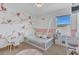 Cozy bedroom with a unique bird-themed wallpaper, play-kitchen, and a modern teepee style bed at 374 Pine Tree Bridge Trl, St Cloud, FL 34772