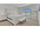 Bright bedroom with white finishes and a view of the pond at 374 Pine Tree Bridge Trl, St Cloud, FL 34772