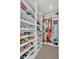 Walk-in closet features custom shelving for shoes, folded clothes, and hanging garments at 374 Pine Tree Bridge Trl, St Cloud, FL 34772