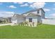 Two-story home featuring a well-manicured lawn, front landscaping, and a two-car garage on a sunny day at 374 Pine Tree Bridge Trl, St Cloud, FL 34772