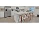 Well-appointed kitchen with white countertops, stainless steel appliances, and a large island with barstool seating at 374 Pine Tree Bridge Trl, St Cloud, FL 34772