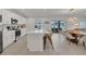 Bright, open kitchen with stainless steel appliances, large island, and seamless flow to the dining area at 374 Pine Tree Bridge Trl, St Cloud, FL 34772