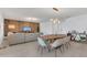 Open floor plan with living room and dining area with modern lighting and neutral color palette at 374 Pine Tree Bridge Trl, St Cloud, FL 34772