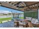 Covered patio with outdoor seating and trampoline overlooking the lake at 374 Pine Tree Bridge Trl, St Cloud, FL 34772