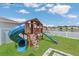 Backyard playset featuring a slide, climbing area, and a lake view at 374 Pine Tree Bridge Trl, St Cloud, FL 34772