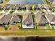 Aerial view of houses with lake view and spacious backyard with patio at 3844 Cabo Rojo Dr, St Cloud, FL 34772