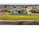 Aerial view of a well-manicured backyard near a lake with a privacy fence at 3844 Cabo Rojo Dr, St Cloud, FL 34772