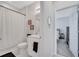 Bathroom features a decorative mirror, patterned shower curtain, and warm sconce lighting at 3844 Cabo Rojo Dr, St Cloud, FL 34772