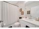 Clean and bright bathroom featuring a white vanity, patterned shower curtain, and neutral wall decor at 3844 Cabo Rojo Dr, St Cloud, FL 34772