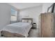 Inviting bedroom showcasing a rustic wood bed frame, a coordinating dresser, and soft natural light at 3844 Cabo Rojo Dr, St Cloud, FL 34772