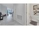 Hallway view of living area and a half bath with tile flooring and neutral walls at 3844 Cabo Rojo Dr, St Cloud, FL 34772