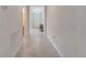 Tiled hallway with view of entry, natural light, and neutral color scheme at 3844 Cabo Rojo Dr, St Cloud, FL 34772
