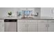 Contemporary kitchen island with stainless steel dishwasher and sink, connecting to the living area at 3844 Cabo Rojo Dr, St Cloud, FL 34772