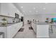 Modern kitchen featuring white cabinets, an island, stainless steel appliances, and open concept layout at 3844 Cabo Rojo Dr, St Cloud, FL 34772