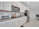 Updated kitchen featuring stainless steel appliances and white cabinets with modern fixtures at 3844 Cabo Rojo Dr, St Cloud, FL 34772