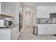 Bright kitchen features white cabinets, stainless steel appliances and gray countertops at 3844 Cabo Rojo Dr, St Cloud, FL 34772