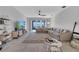 Bright living area with comfortable seating, decorative rug, and entertainment center at 3844 Cabo Rojo Dr, St Cloud, FL 34772