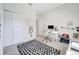 Well-lit office features a polka dot rug, white desk and rolling chair, and neutral walls at 3844 Cabo Rojo Dr, St Cloud, FL 34772