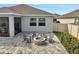 Outdoor patio with seating area and a stone fire pit at 3844 Cabo Rojo Dr, St Cloud, FL 34772