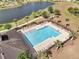 Community pool with lounge chairs and umbrellas, a spa, and view of the lake at 3844 Cabo Rojo Dr, St Cloud, FL 34772