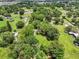 Wide aerial view showcasing the property with lush greenery and a pond at 429 Diamond Acres Rd, Davenport, FL 33837