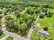 Wide aerial view of a property featuring lush landscaping, a home and long driveway at 429 Diamond Acres Rd, Davenport, FL 33837