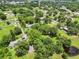 Expansive aerial view showcasing the property with lush greenery and a pond at 429 Diamond Acres Rd, Davenport, FL 33837