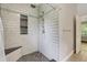 Modern bathroom shower with rock floor, tiled walls, and built-in shelving at 429 Diamond Acres Rd, Davenport, FL 33837
