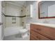 Well-lit bathroom with vanity, toilet, shower, tub, and tiled walls at 429 Diamond Acres Rd, Davenport, FL 33837
