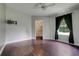Bright bedroom with wood floors, closet, ceiling fan, and television at 429 Diamond Acres Rd, Davenport, FL 33837
