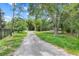 Long driveway surrounded by trees and foliage at 429 Diamond Acres Rd, Davenport, FL 33837