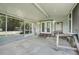 Covered porch with screened windows, concrete floor, and plenty of space at 429 Diamond Acres Rd, Davenport, FL 33837