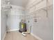 Water heater inside a storage area with tiled floors and plenty of shelving at 429 Diamond Acres Rd, Davenport, FL 33837