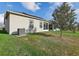 View of backyard of home with lush green lawn and exterior with solar panels at 4324 Desert Rose, Kissimmee, FL 34746