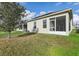 Backyard view featuring solar panels and a screened patio at 4324 Desert Rose, Kissimmee, FL 34746