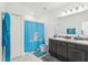 Bathroom featuring double sinks and Miami Dolphin-themed decor at 4324 Desert Rose, Kissimmee, FL 34746