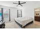 Comfortable bedroom featuring neutral walls, carpet flooring, two windows, and a ceiling fan at 4324 Desert Rose, Kissimmee, FL 34746