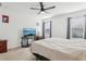 Comfortable bedroom featuring neutral walls, carpet flooring, three windows, and a ceiling fan at 4324 Desert Rose, Kissimmee, FL 34746