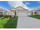 Charming single-story home with a two-car garage, landscaped yard, and covered front porch at 4324 Desert Rose, Kissimmee, FL 34746
