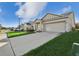 Well-maintained home featuring a two-car garage, driveway, green lawn and manicured landscaping at 4324 Desert Rose, Kissimmee, FL 34746