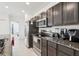 Updated kitchen featuring stainless steel appliances, granite countertops, and dark wood cabinetry at 4324 Desert Rose, Kissimmee, FL 34746